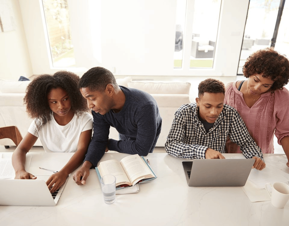 A family helping a student with schoolwork